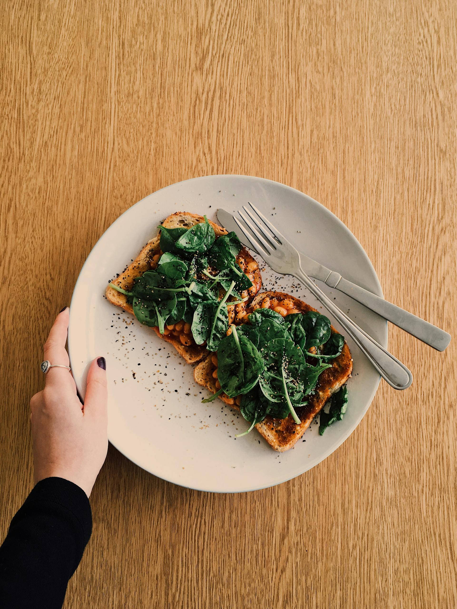 Plate of toast with spinach, perfect for a wholesome breakfast, photographed flat lay.